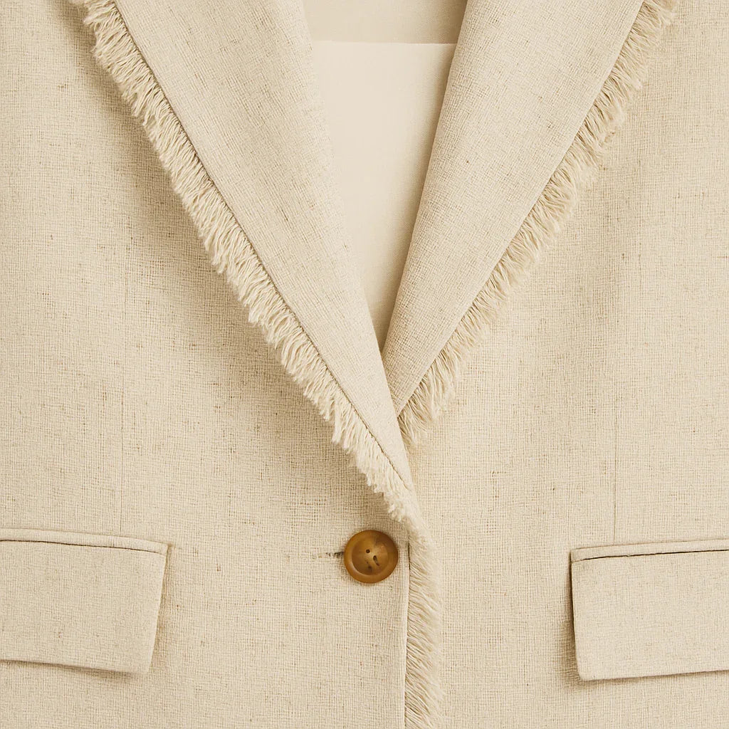 Beige kavaj med fransad revers och enkelknappsstängning